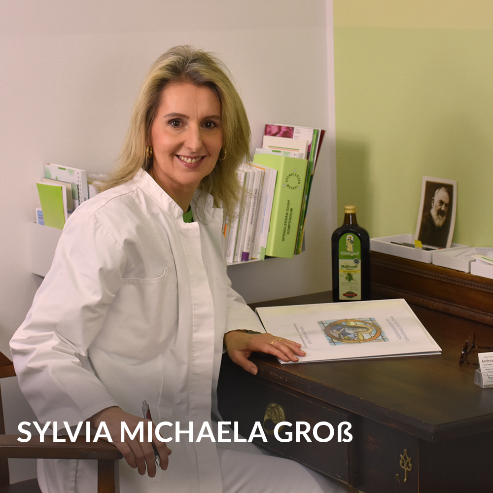 Blonde pretty doctor sitting at her place in the office